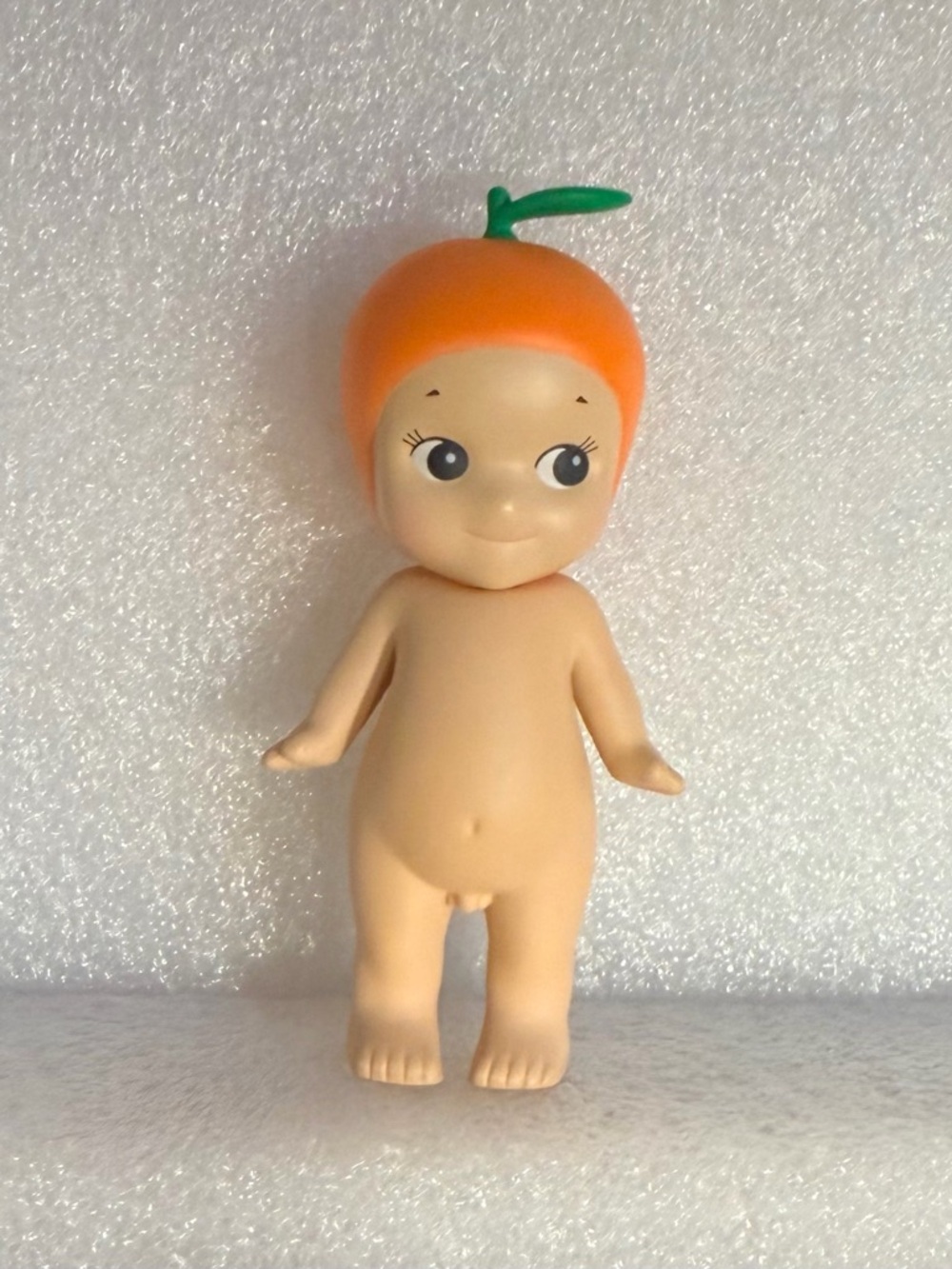 Orange-Top Kewpie-Style Doll with Green Leaf Accent
